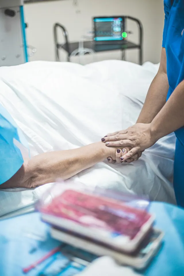 Caretaker attending to a bedridden patient